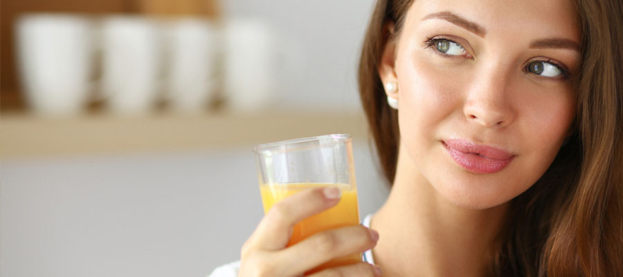 young woman drinking orange juice