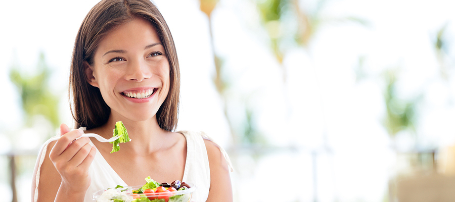 Woman eating a salad.