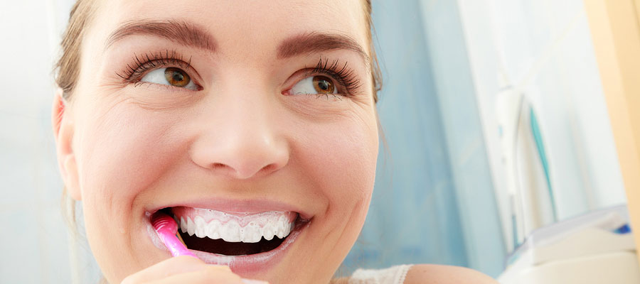Woman brushing teeth.