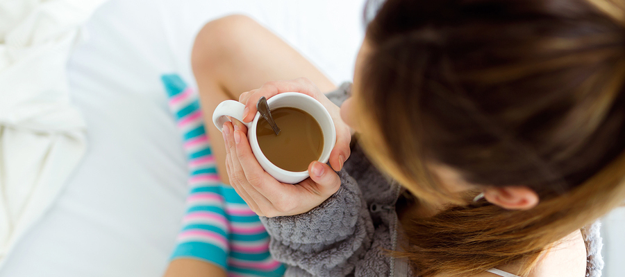 Woman with a hot cup of coffee.