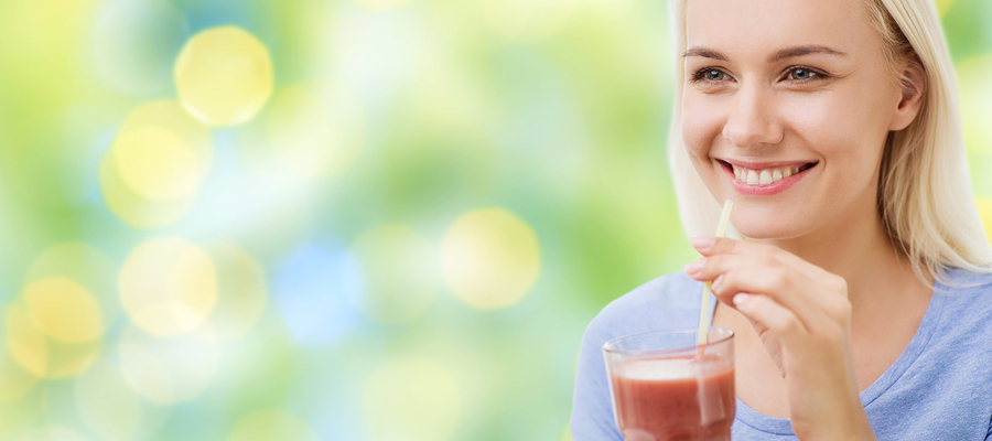Woman drinking a cold drink through a straw