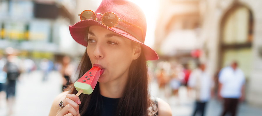 Woman eating a popsicle.