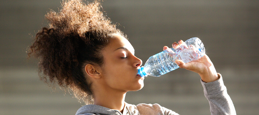 Woman drinking from water bottle