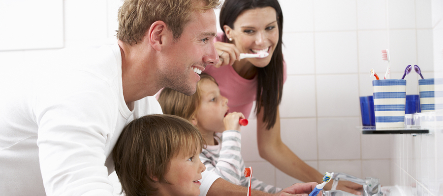 Woman preparing to brush her teeth with fluoride toothpaste