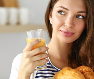 young woman drinking orange juice