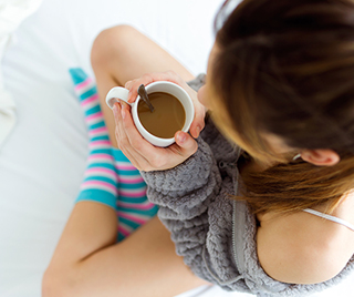 Woman with a hot cup of coffee.