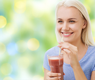 Woman drinking a cold drink through a straw