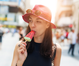 Woman eating a popsicle.