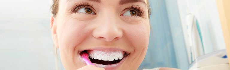 Woman brushing teeth.