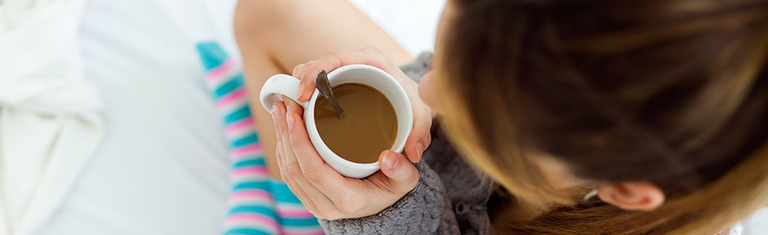 Woman with a hot cup of coffee.